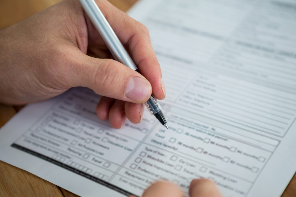 Businesswoman filling last will and testament form